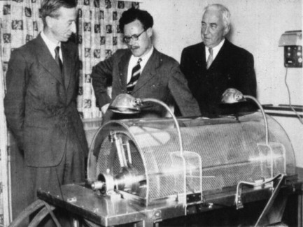 Frank Parsons demonstrates new rotating drum kidney to man in suit