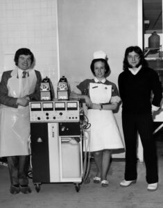 Two doctors and a nurse beside a dialysis machine. The nurse has attitude. 